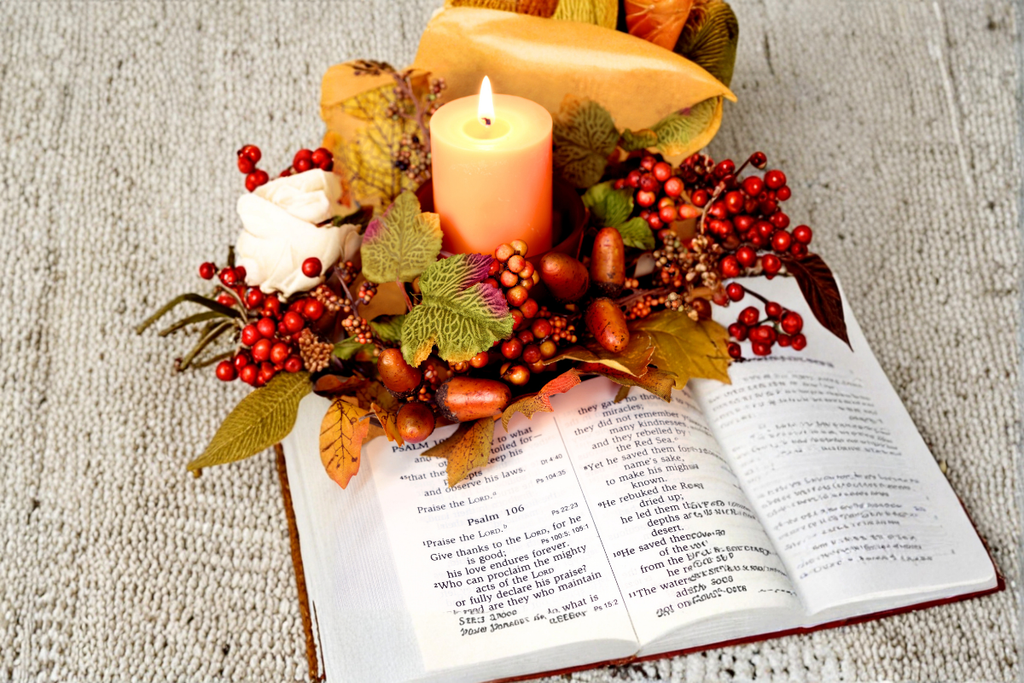 candle, open Bible and thanksgiving items