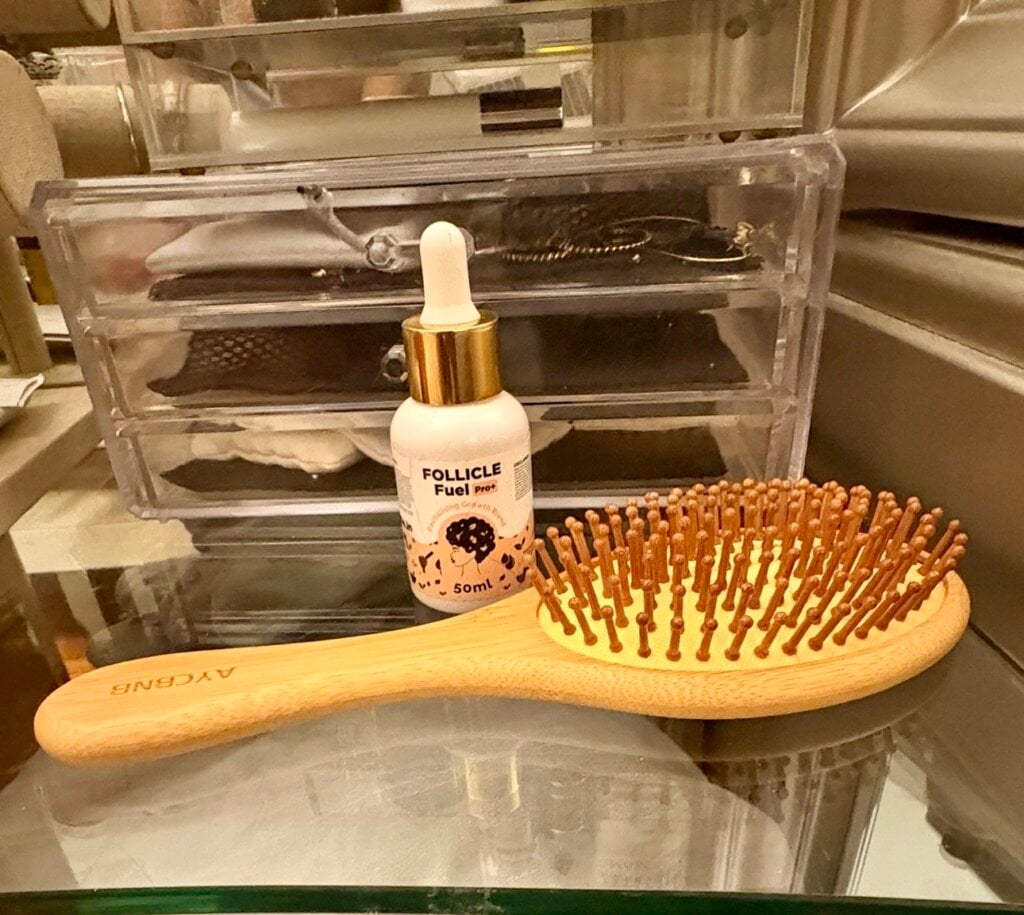 scalp massage brush and hair growth oil