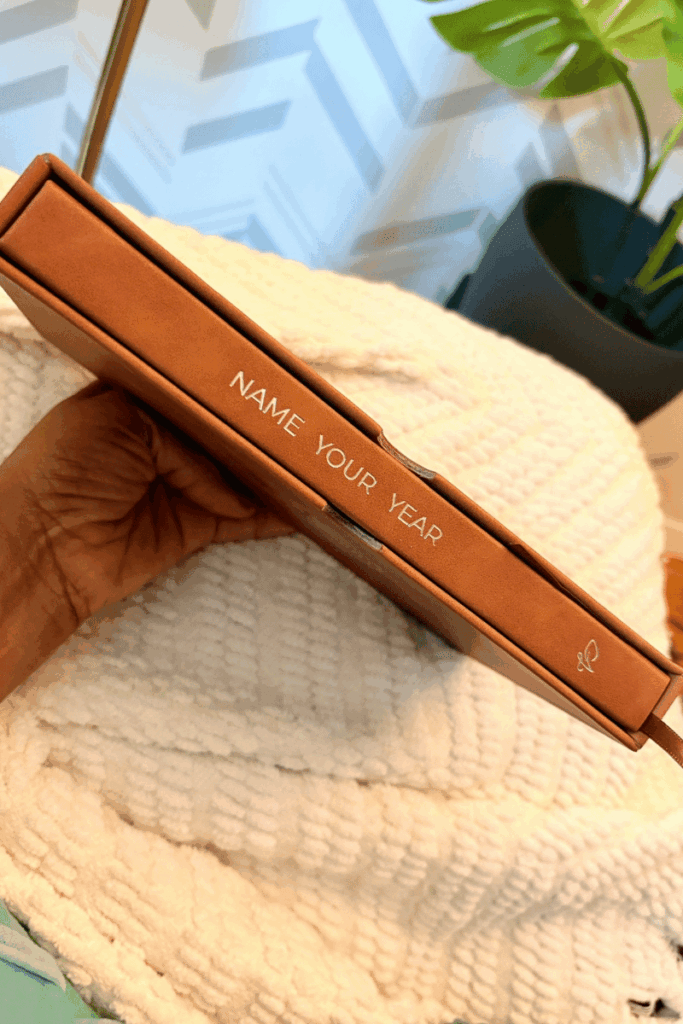 hand holding, the james method's brown name your year journal
