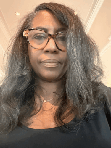 black woman with long graying fine natural hair