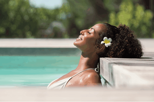 natural hair woman laying outside on a summer day