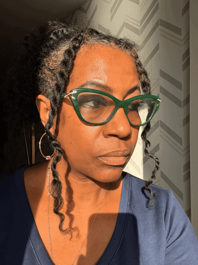 woman with fine natural hair looking introspectively