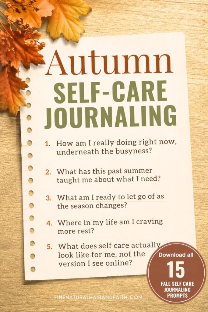 A torn journal page on a wood table with autumn leaves, showing five autumn self care journaling prompts to reflect on this fall.