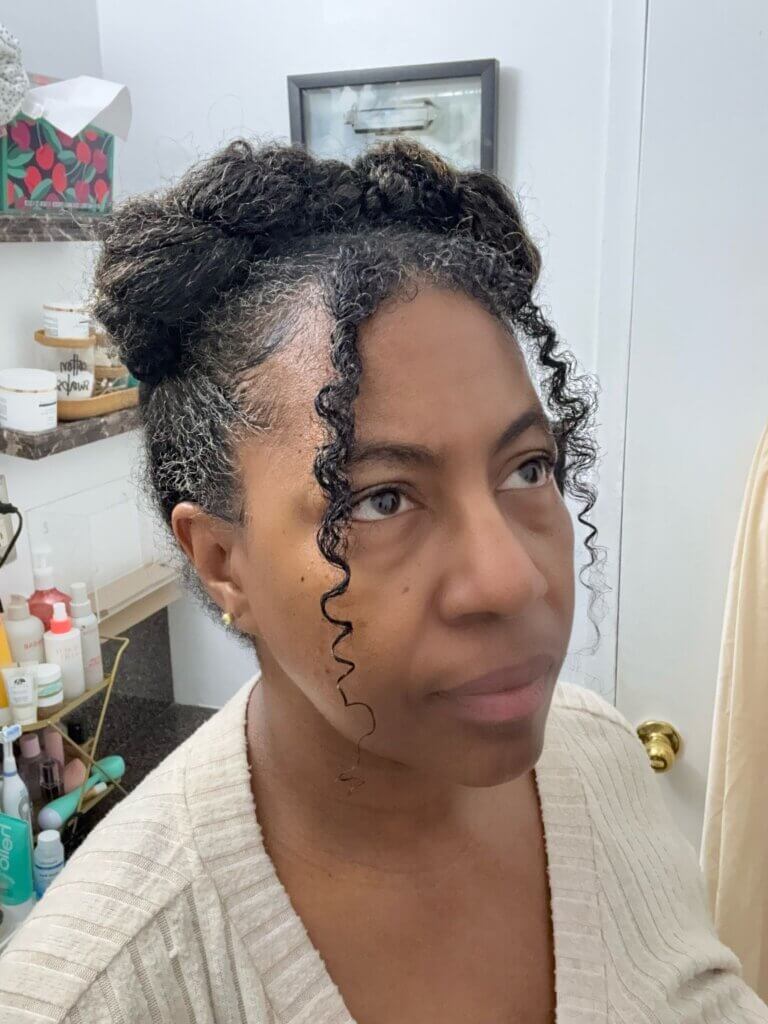 Side view of crossover crown braid hairstyle with curly tendrils