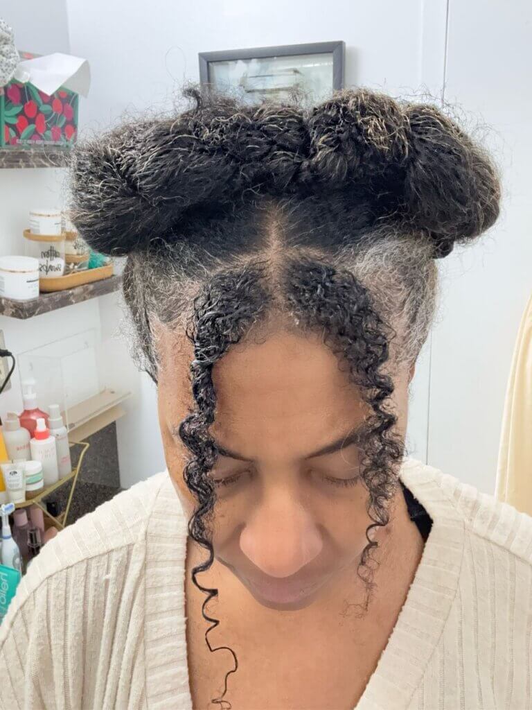 Top view of crossover crown braids with defined curly tendrils in front