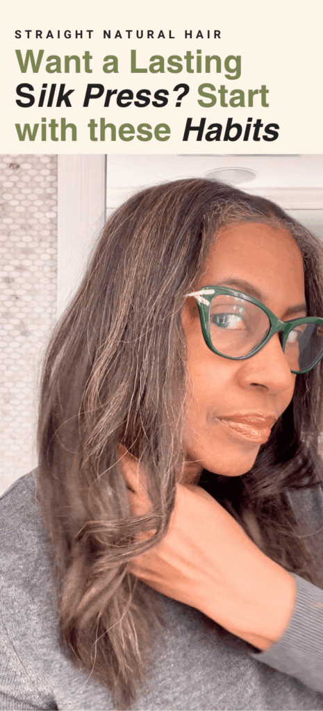 Woman with long, straight natural hair and visible gray strands wearing green glasses. Text reads, “Straight Natural Hair: Want a Lasting Silk Press? Start With These Habits.”