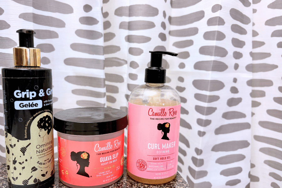 three curly hair products on a counter