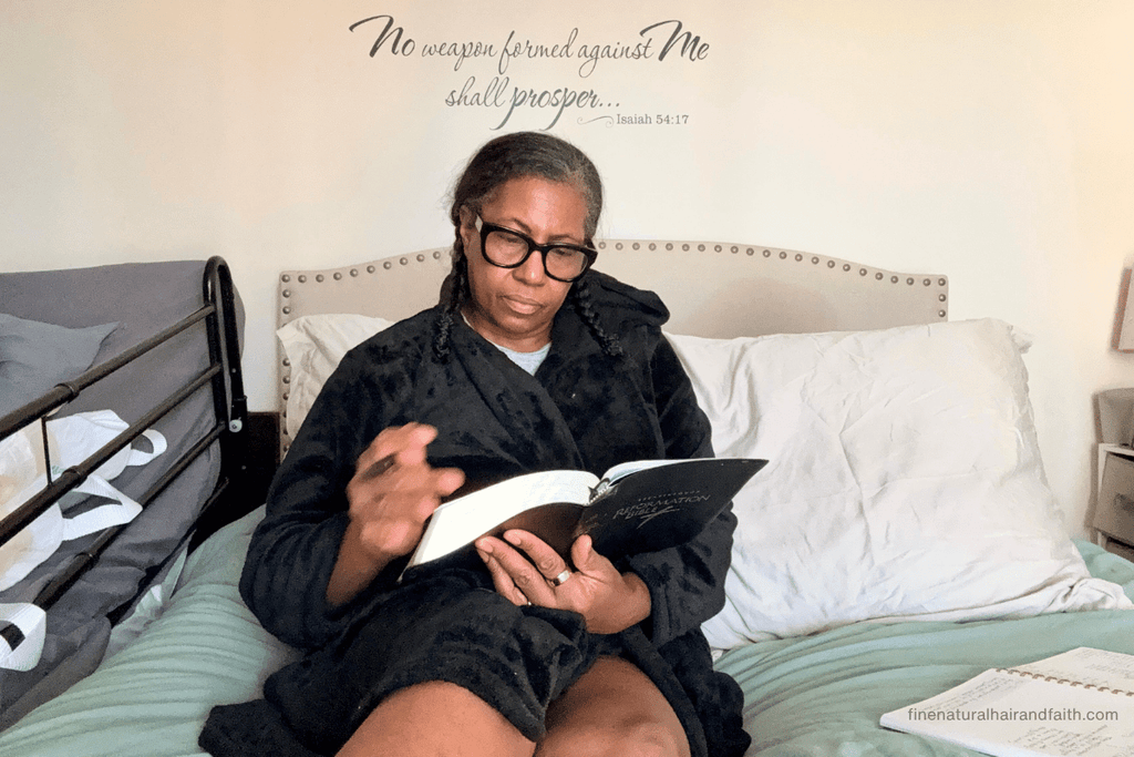 Christian woman sitting and relaxing with her Bible and journal while practicing Sabbath rest.